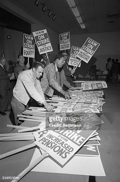 Detroit, MI-With a strike against the General Motors Corporation almost certain at midnight 9/14, members of UAW Local 22 prepare placards for use by...