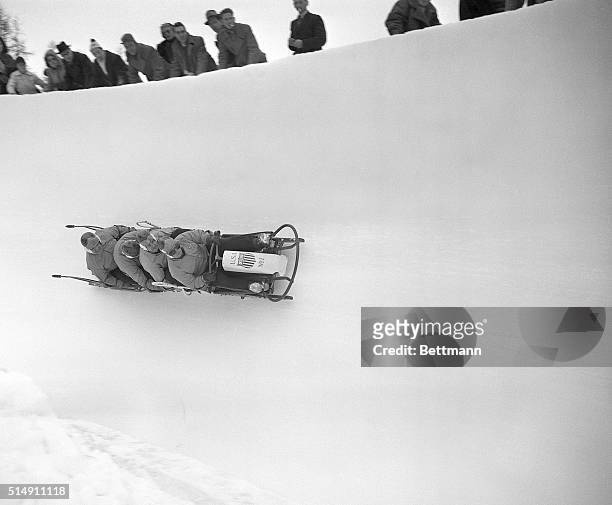 St. Moritz, Switzerland- The United States first place bobsled team is shown defying gravity, seeming to hang onto the air, as the racing sled...