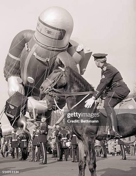 New York, New York- Sergeant Frank Ford of New York City's Mounted Police steadies his horse as the mommoth "Space Cadet" in Macy's Thanksgiving Day...