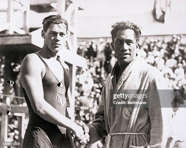 Paris, France- The 1924 Olympic swimmers in France. Duke Kahanamoku and Johnny Weismuller, both from the United States shake hands.