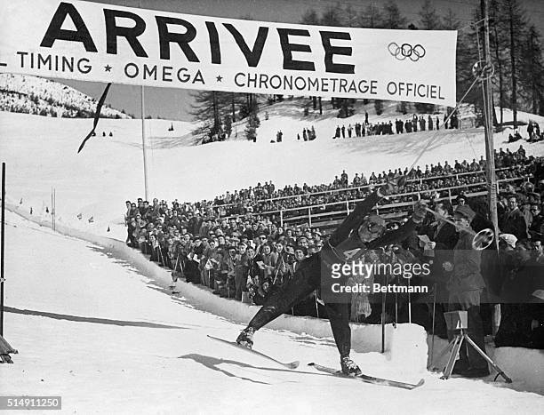 St.Moritz, Switzerland- Henri Oreiller of France raises his hands in spectacular manner as he crosses the finish line in the combined Slalom race....