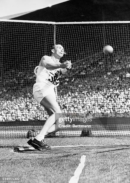 London, England- Imry Nemeth of Hungary strains all muscles as he is about to release the hammer during the Olympic contest at Empire Stadium,...