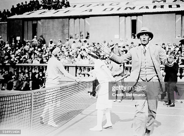 Cannes,France- This is the first photo to arrive in America showing Suzanne Lenglen shaking hands with our own Helen Wills who lost. The gentleman in...