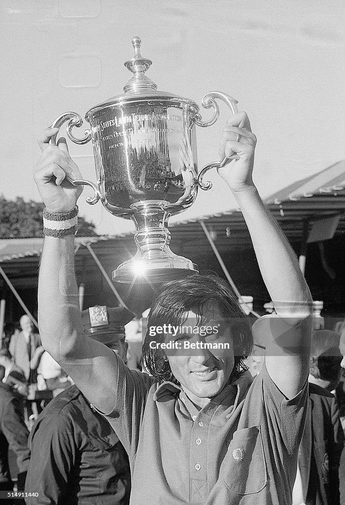 Ilie Nastase Holding U.S. Open Trophy