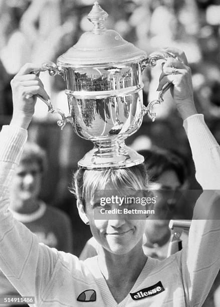 New York, New York- Chris Evert Lloyd wins her 6th US Open 9/11, defeating Hana Mandlikova: 6-3, 6-1. She is holding her trophy on top of her head.