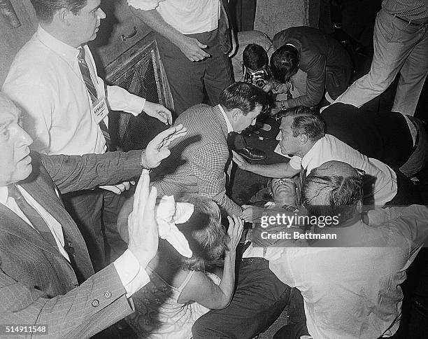 Los Angeles, CA- Shirt open, one eye closed, Sen. Robert F. Kennedy lies on the floor of the Ambassador Hotel after being shot by a man identified as...