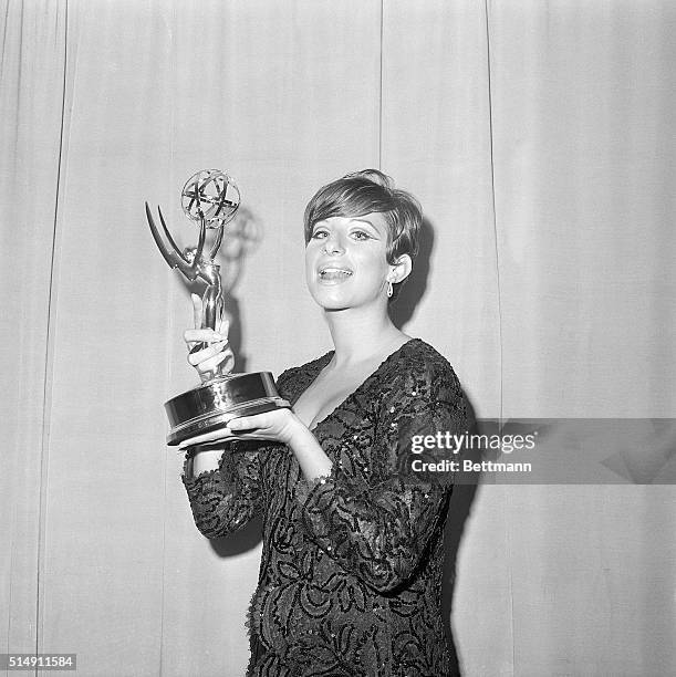 Radiant Barbara Streisand is shown holding the Emmy award she won for outstanding achievement presented to her here late September 12 at television's...