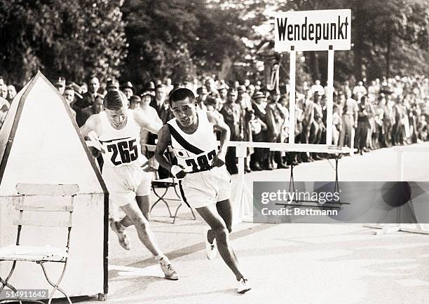 Berlin, Germany- Korean athlete Sohn Kee-chung , being followed closely by Ernest Harper, Great Britain, nearing the homestretch in the Olympic...