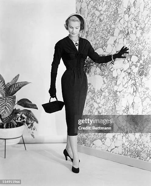 New York, New York- Sleek, drapable crepe of Du Pont rayon for this figure-flattering "little black dress" designed by Nettie Rosenstein. This...