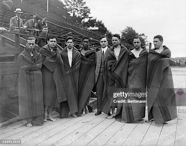 Stockholm, Sweden: American men's swimming team is shown at the Olympic Gaems in Sweden. They are each wrapped in a large towel.