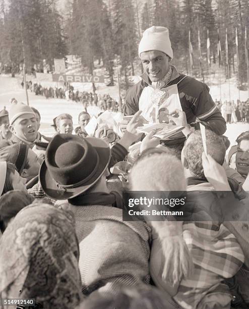 Cortina D'Ampezzo, Italy- Toni Sailer of Austria, 20-year-old ski prodigy, is carried on the shoulders of fans after winning the men's giant slalom...