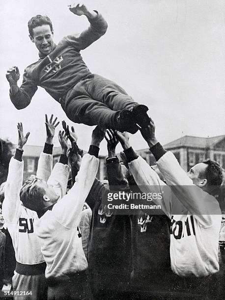 London, England- Picture shows captain W.O.G. Grut, of Sweden, winner of the pentathlon, getting an enthusiastic tossing by members of the team at...