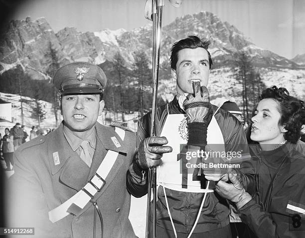 Austrian skier Toni "Wonder Boy" Sailer stands with his sister, Rosl, and a soldier following his victory in the men's downhill competition at the...