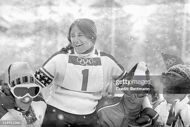 Sapporo, Japan- The U.S.A.'s Barbara Cochran is carried on the shoulders of her brother Bob Cochran and Rick Chafee after she won a first place in...