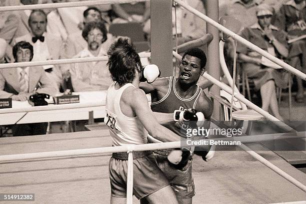 Montreal, Canada- USA's Leon Spinks of St. Louis, Missouri connects with a right to Poland's Janusz Gortat, during their semi-final Olympic bout....