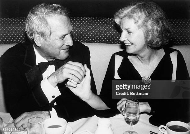 New York, NY- Paul Newman and wife Joanne Woodward hold hands and gaze romantically into each others eyes, at a private dinner party at the...