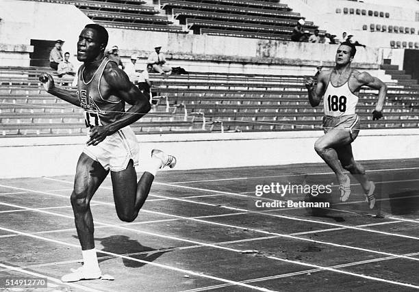 Rome, Italy- America's Rafer Johnson of Kingsburg, California sprints home to win his heat in the 100-meter dash, the first event in the decathlon....
