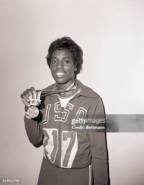 Tokyo, Japan- America's Wyomia Tyus appears overjoyed here, after receiving her gold medal for winning the women's 100-meter dash in the Olympic...