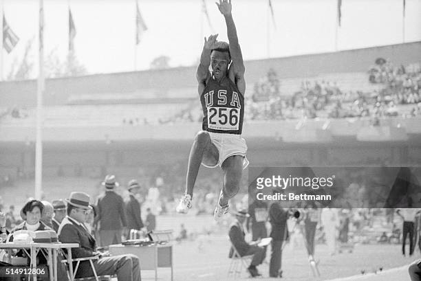 Mexico City, Mexico- Here's the giant, record-breaking leap of Memphis, TN, Olympic star Ralph Boston, who jumped 27 feet, 1 3/4 inches 10/17 on his...