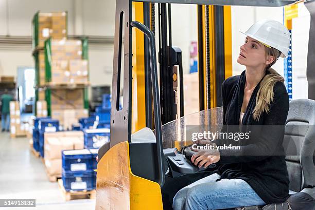 woman driving forklift - picking up stock pictures, royalty-free photos & images