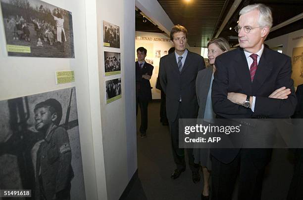 French Foreign Minister Michel Barnier followed by his wife Isabelle Barnier view an upcoming exhibition at a new museum in the Yad Vashem Holocaust...