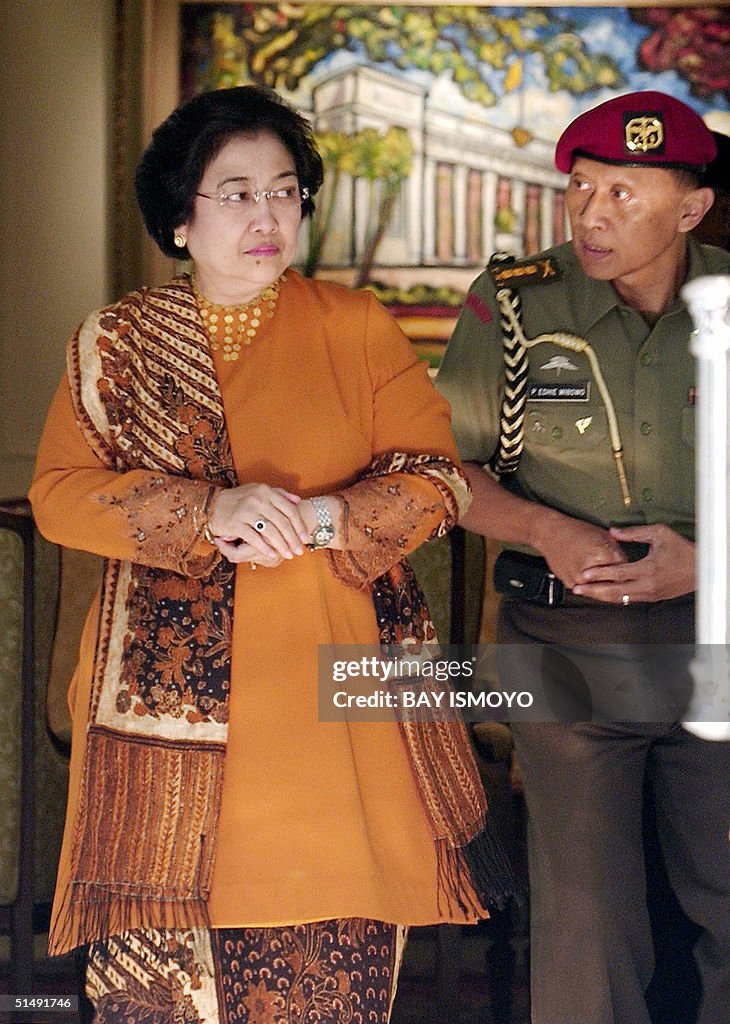 Indonesian President Megawati Sukarnoputri leaves her office for the ...