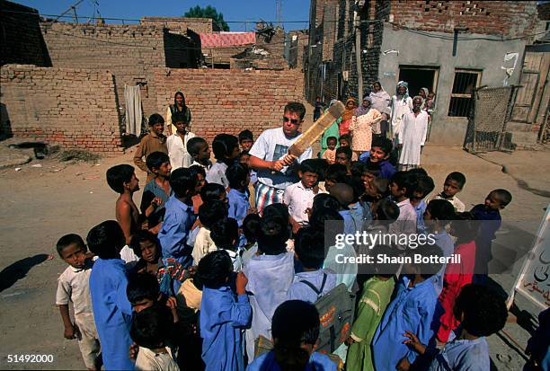 Mark Taylor of Australia gives some batting advice to Pakistani children during the Australian tour of Pakistan between September 23 and November 5,...