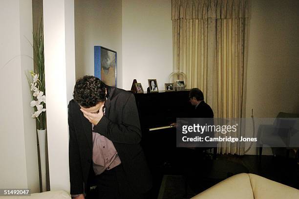 Actor Andrew Lincoln who has starred in shows "This Life" and "Teachers" with fellow actor Bill Nighy in the background on the piano pose during a...
