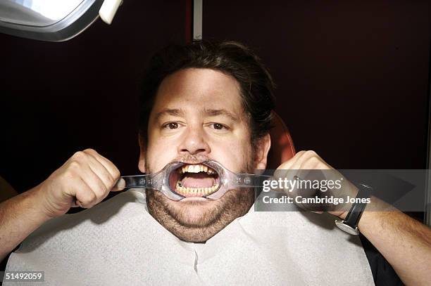 Comedian Johnny Vegas poses at the dentists for a photo call held on December 2, 2003 in London.