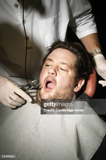 Comedian Johnny Vegas poses at the dentists for a photo call held on December 2, 2003 in London.