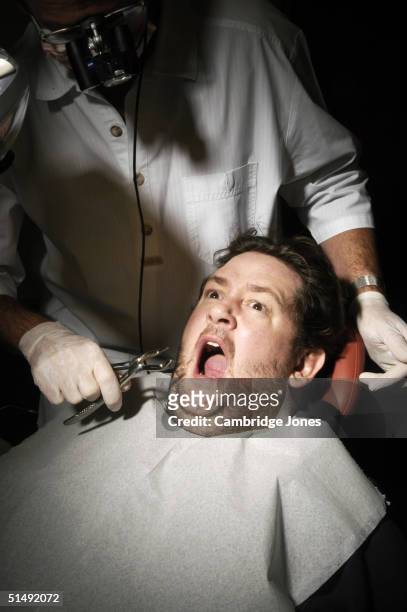 Comedian Johnny Vegas poses at the dentists for a photo call held on December 2, 2003 in London.