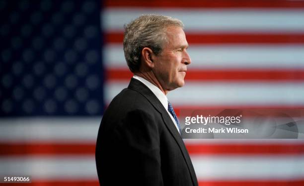 President George W. Bush listens to his introduction before speaking to a crowd of supporters at the Evesham Recreation Center October 18, 2004 in...