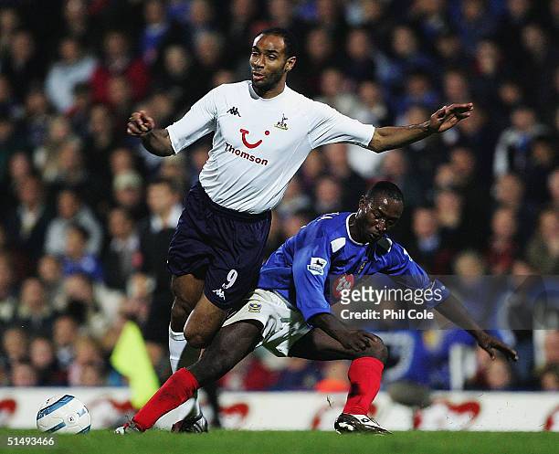 Frederic Kanoute of Tottenham gets tackled by Lomana Tresor Lua Lua of Portsmouth during the Barclays Premiership match between Portsmouth and...
