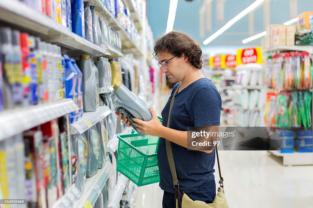 Man with canister of motor oil