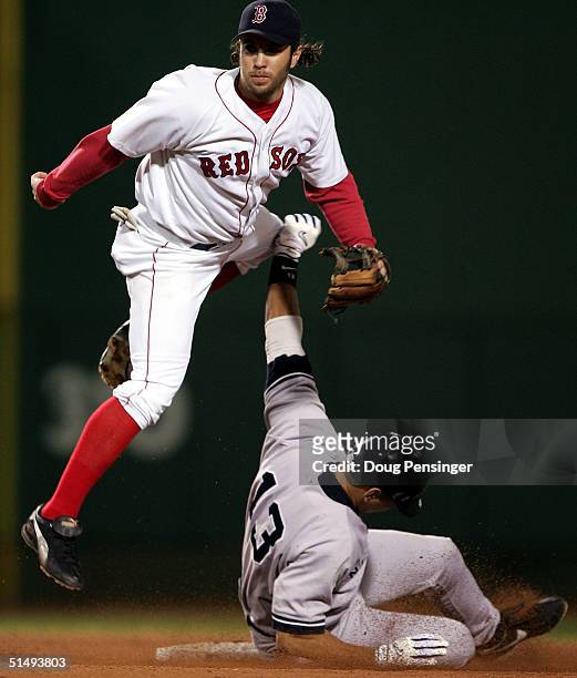 Mark Bellhorn of the Boston Red Sox leaps over Alex Rodriguez of the New York Yankees after completing a double-play on a ball hit by Gary Sheffield...