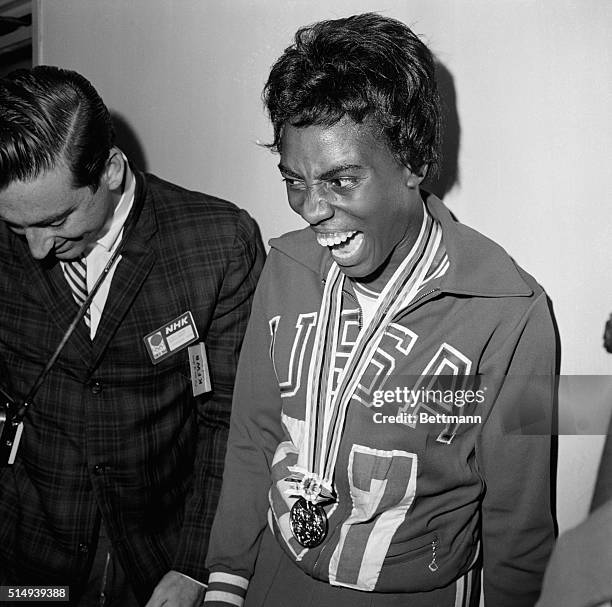 Tokyo, Japan- America's Wyomia Tyus appears overjoyed after receiving her gold medal for the women's 100-meter dash in the Olympic Games. She won the...