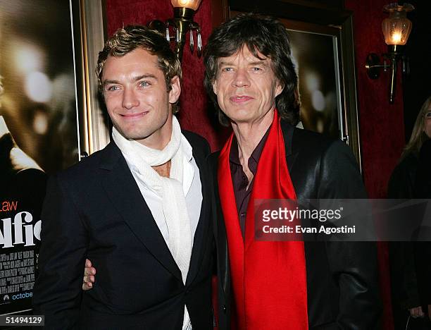 Actors Jude Law and Mick Jagger attend the New York Premiere of "Alfie" at The Ziegfeld Theatre on October 18, 2004 in New York City.