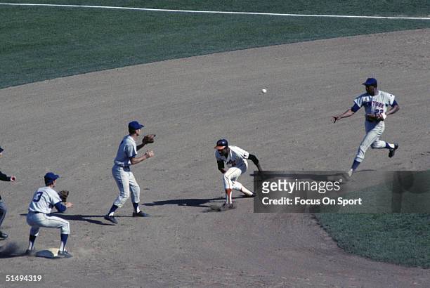 First baseman Donn Clendenon of the New York Mets flips to Al Weis of the Mets to nail Paul Blair of the Baltimore Orioles, who was caught in the run...