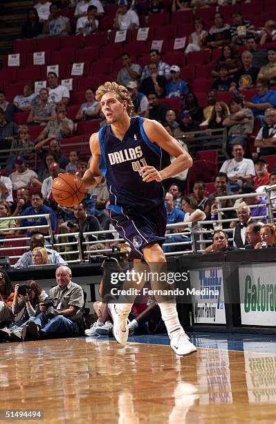 Dirk Nowitzki of the Dallas Mavericks dribbles up court against the Orlando Magic during a preseason game on October 17, 2004 at TD Waterhouse Centre...