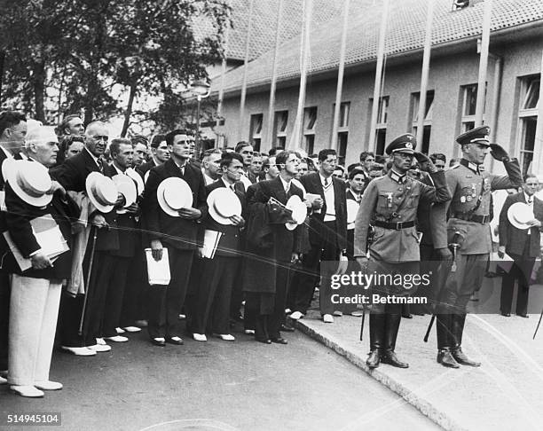 Berlin, Germany: American Team Arrives At Its Olympic Quarters. No Nazi salute here! Members of the American Olympic team use their straw hats to...