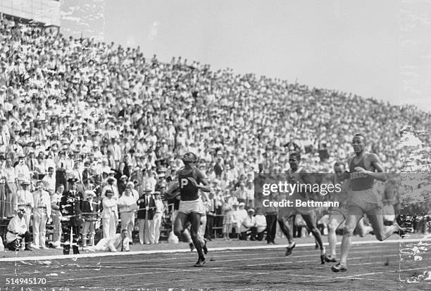 Randall's Island, NY: Jesse Owens leading field to wire as he wins 200 meter final in 21 seconds flat. Mack Robinson, 2nd, and Robert Puckard, 3rd.