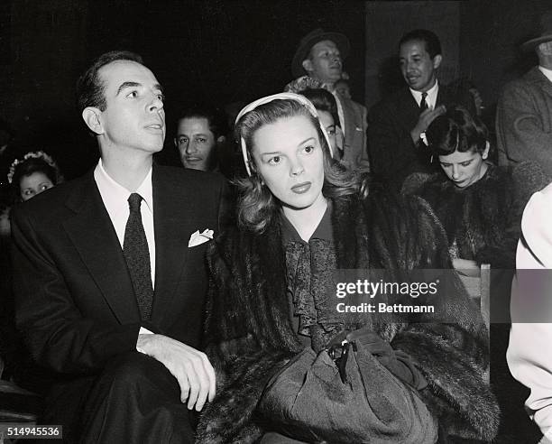 Actress Judy Garland and fiance movie director Vincente Minnelli are shown watching the homecoming show in Los Angeles Memorial Coliseum.