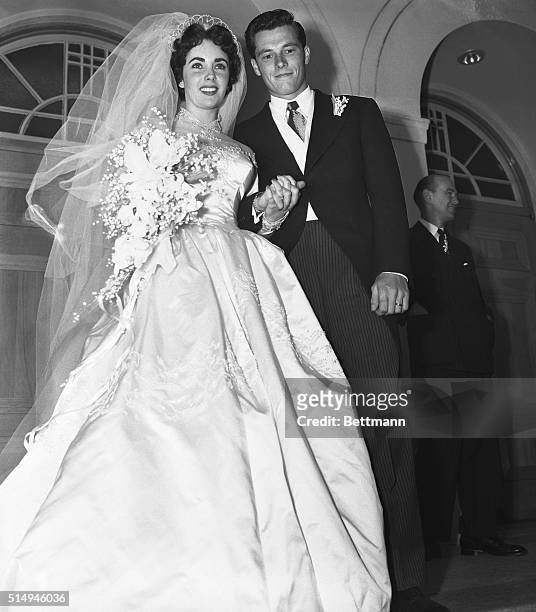 Beverly Hills, CA- Mr. And Mrs. Conrad Hilton Jr., pause on the steps of the Church of the Good Shepherd here after their wedding. The bride is the...