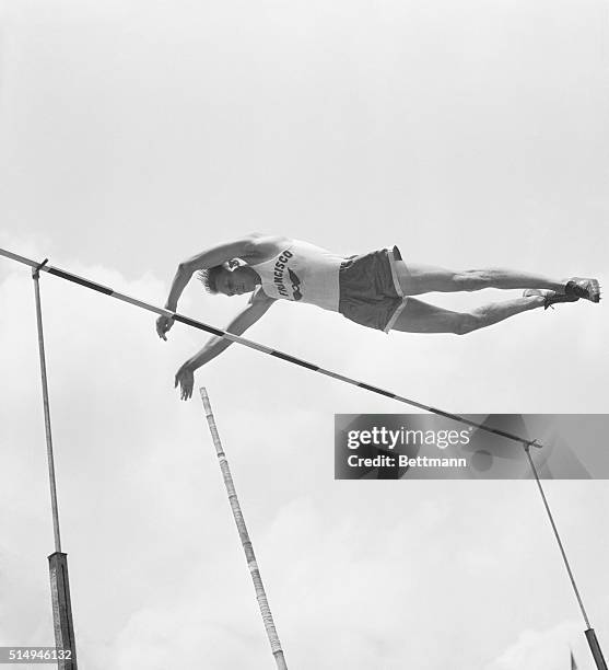 Cornelius Warmerdam of the Olympic Club clears bar at 15 feet, to win the senior pole vault event at the National A.A.U. Track championships in...