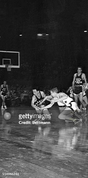 East's Bob Cousy , of Holy Cross, tangles with West's Dick Schnittker of Ohio State and West's George Yardley of Stanford as loose ball bounds out of...