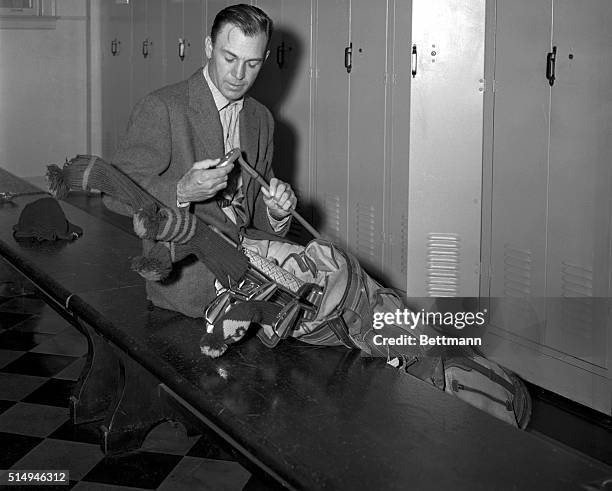 Ben Hogan, ready for a practice round before the opening of the Goodall Round-Robin Tournament, checks his clubs in the locker room at the Wykagyl...