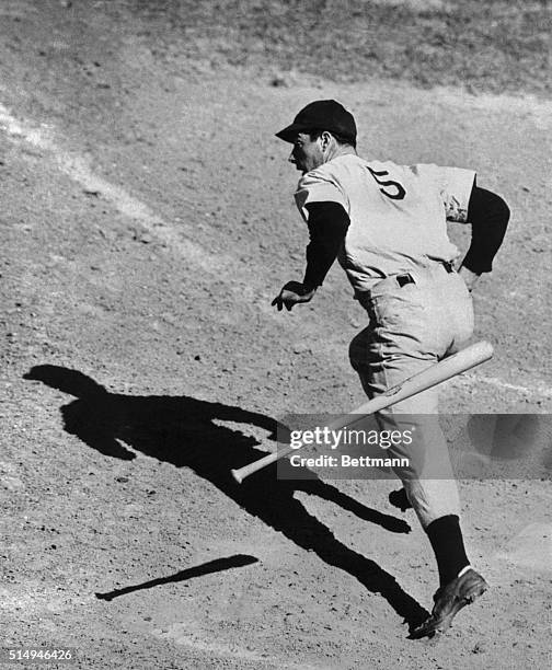 Joe DiMaggio looks surprised even if it seems to be getting a habit to hit regularly in baseball games these days. Joe is shown getting the hit in...