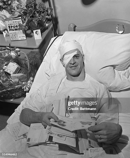 Gordon Howe Detroit Red Wing hockey player, who was injured in the Stanley Cup playoff, is surrounded by flowers, mail, books and fruits as he...