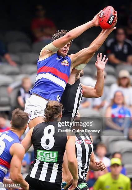 Tom Boyd of the Bulldogs marks over the top of Jarrod Witts of the Magpies during the 2016 NAB Challenge AFL match between the Collingwood Magpies...
