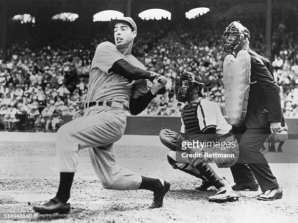 Joe DiMaggio, star slugger of the New York Yankees, is shown belting out his hit for the 53rd consecutive game this year, he made this one against...